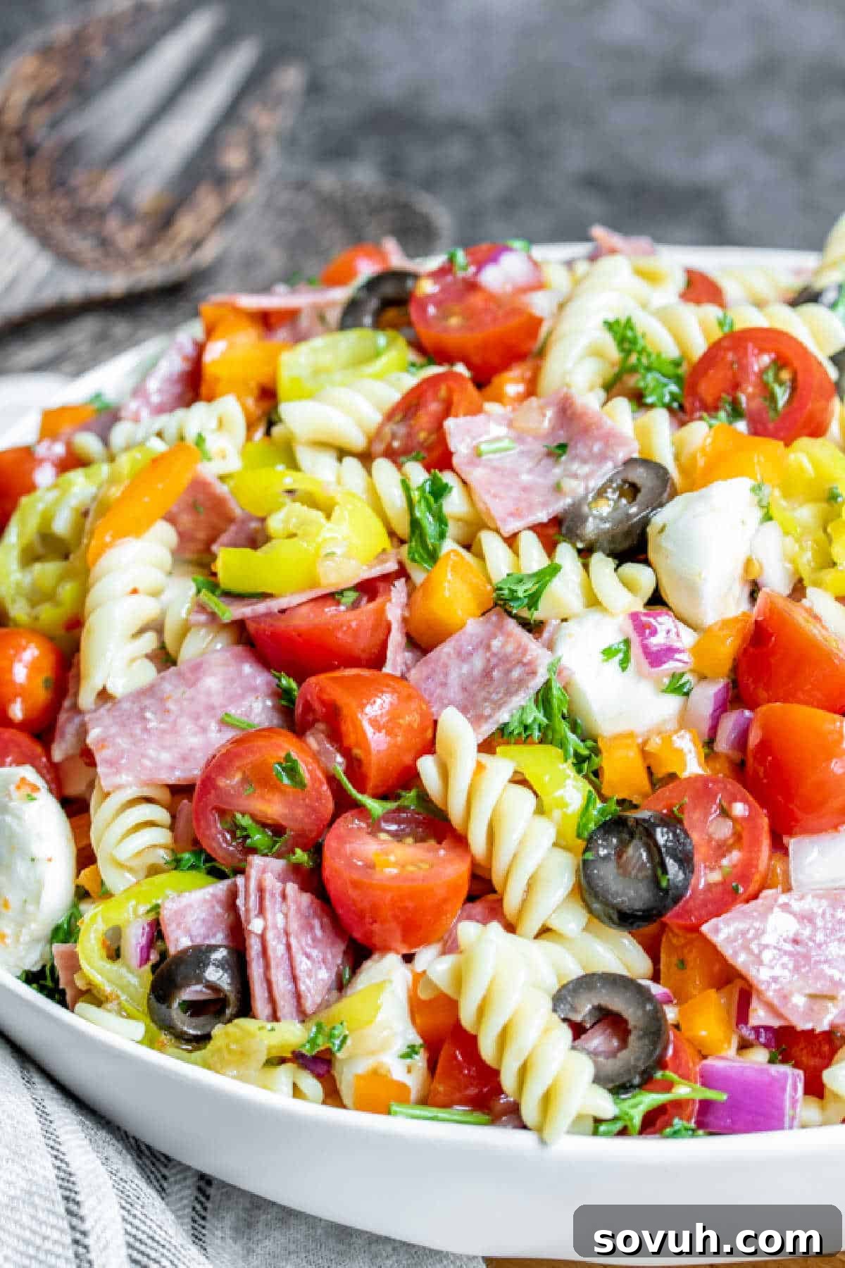 Italian Pasta Salad in a white bowl with a focus on fresh ingredients