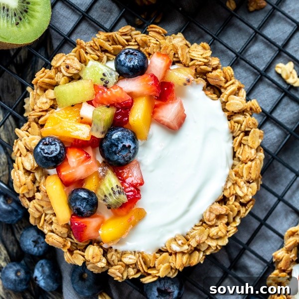 Granola Fruit Tart topped with fresh fruit, showcasing a colorful array of berries and kiwi