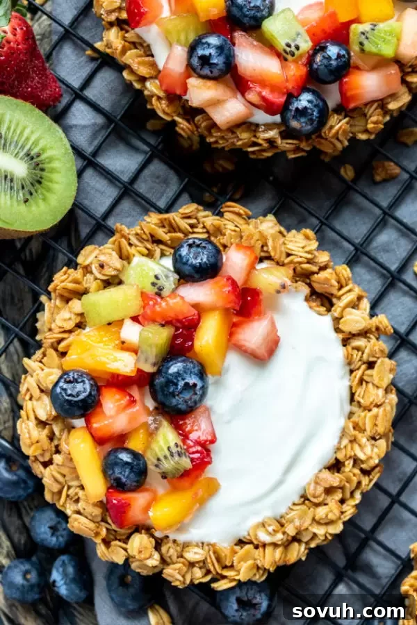 A slice of Granola Fruit Tart being lifted from the main tart, showing its perfect layers and fresh fruit