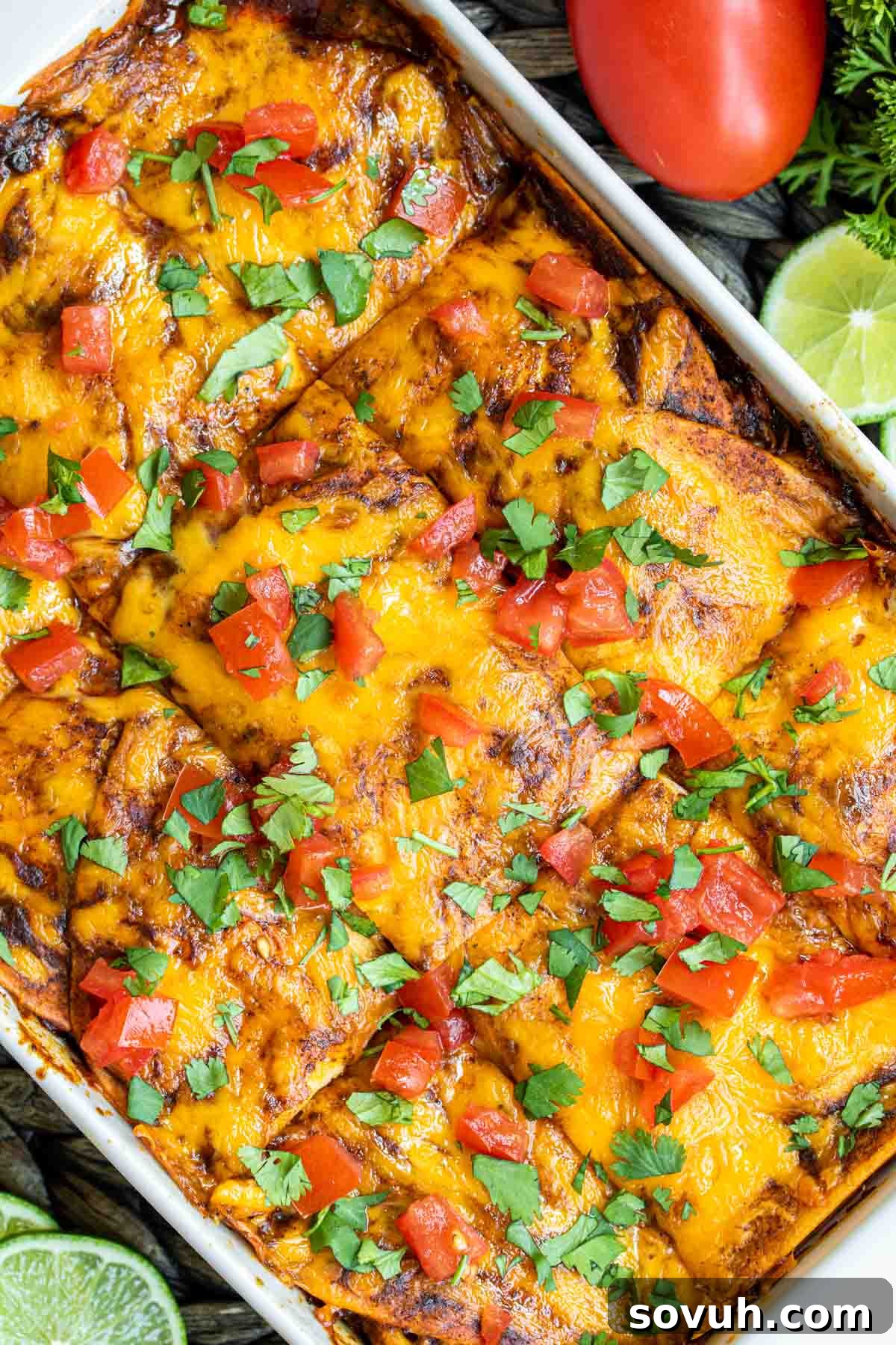 Chicken Enchilada Casserole in white cassorle dish cut into portions