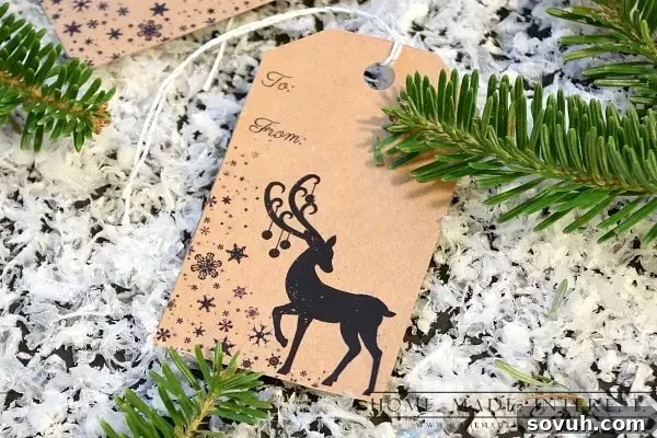 Close-up of a free printable deer Christmas gift tag, precisely cut out and ready to be attached to a holiday present, showcasing intricate detail.
