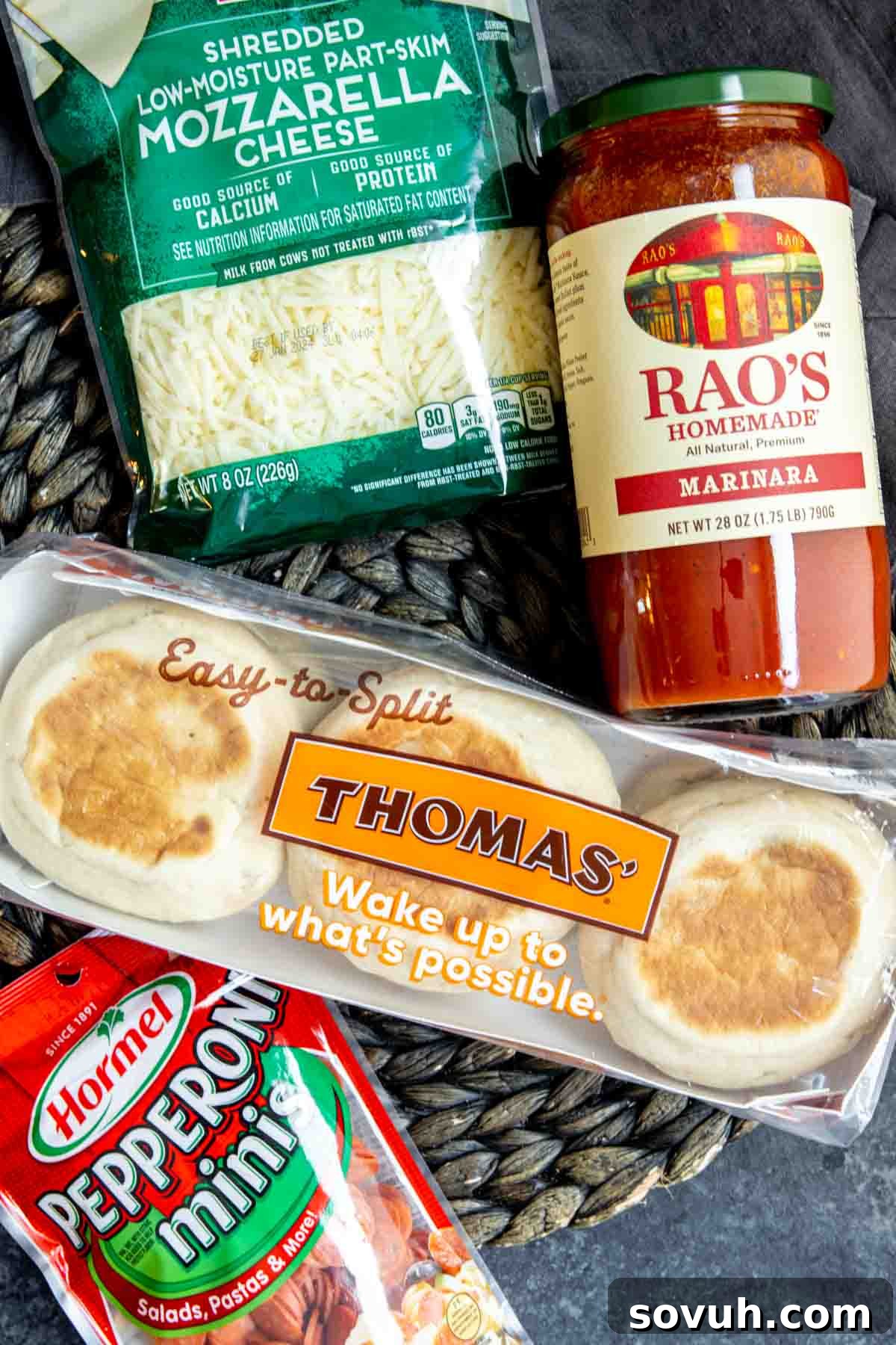 Individual ingredients for English muffin pizzas laid out: English muffins, sauce, cheese, pepperoni.