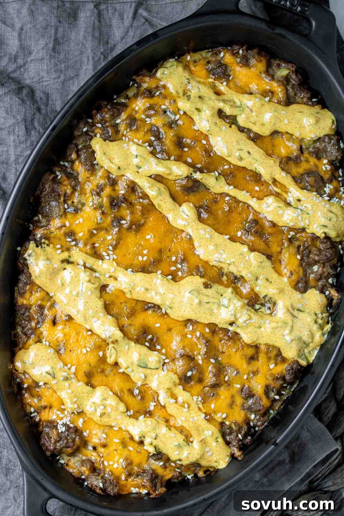 Big Mac Keto Bake 3 A hearty Keto Big Mac Casserole simmering in a black skillet, ready to be served.