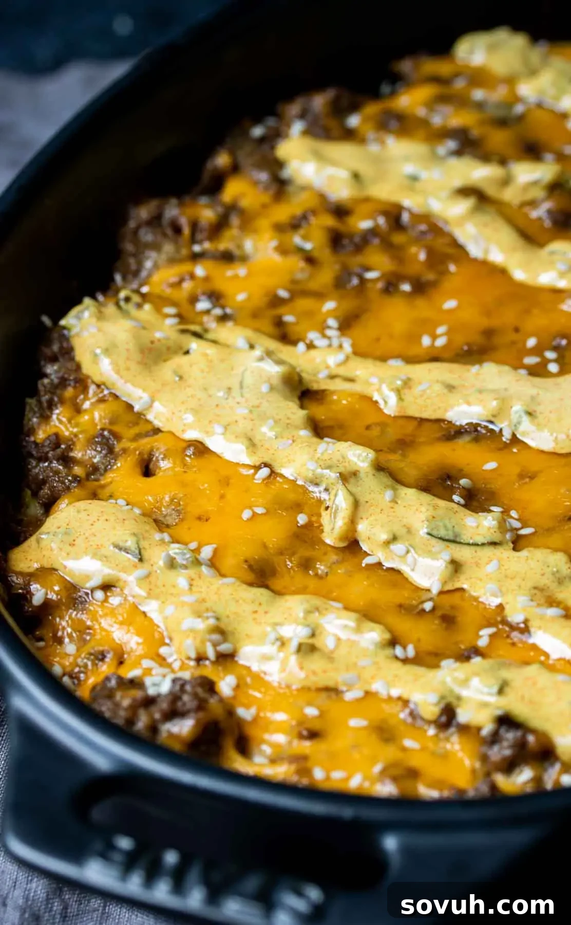 Big Mac Keto Bake 5 Keto Big Mac Casserole served in a cast iron skillet, garnished with fresh toppings.