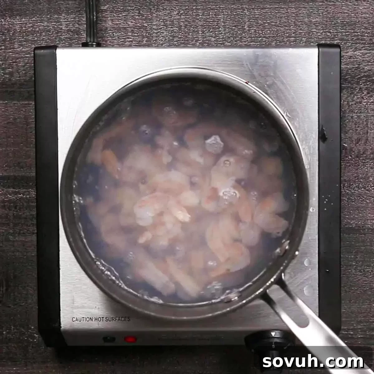 pot of shrimp for Shrimp Casserole, showing raw shrimp turning pink