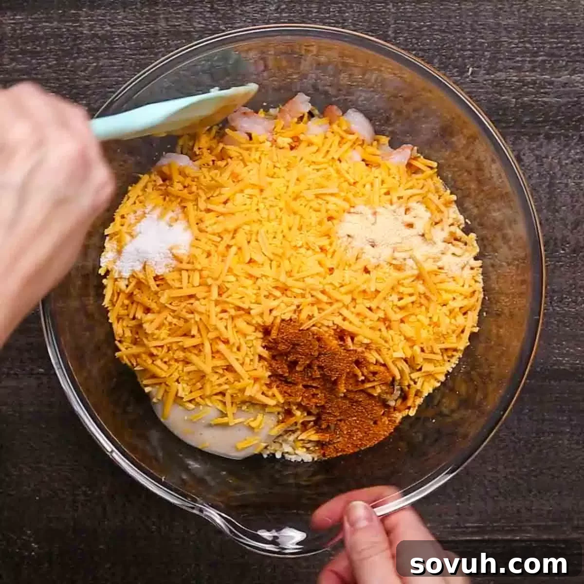 ingredients for Shrimp Casserole, including cooked rice, shrimp, soup, cheese, and spices in bowls
