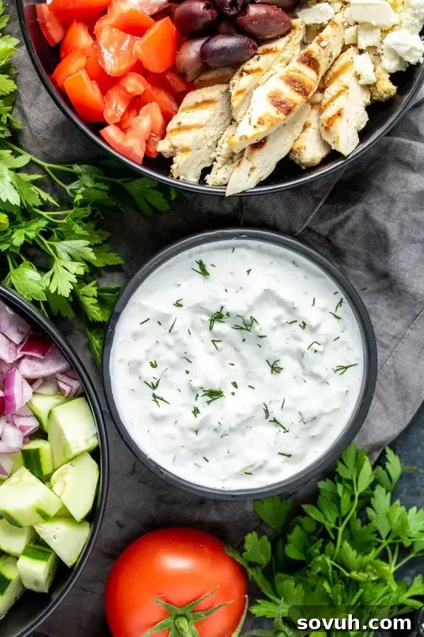 Keto Tzatziki sauce is a low carb dip in a bowl, styled with fresh dill sprigs.