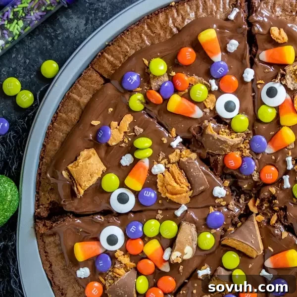 Festive Halloween Dessert Pizza topped with a variety of candy