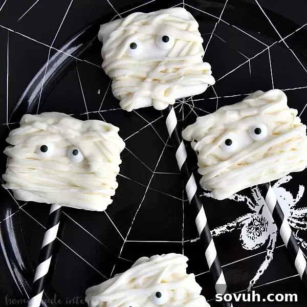 Adorable Mummy Marshmallows, an easy Halloween dessert recipe made with melted candy and large campfire marshmallows.