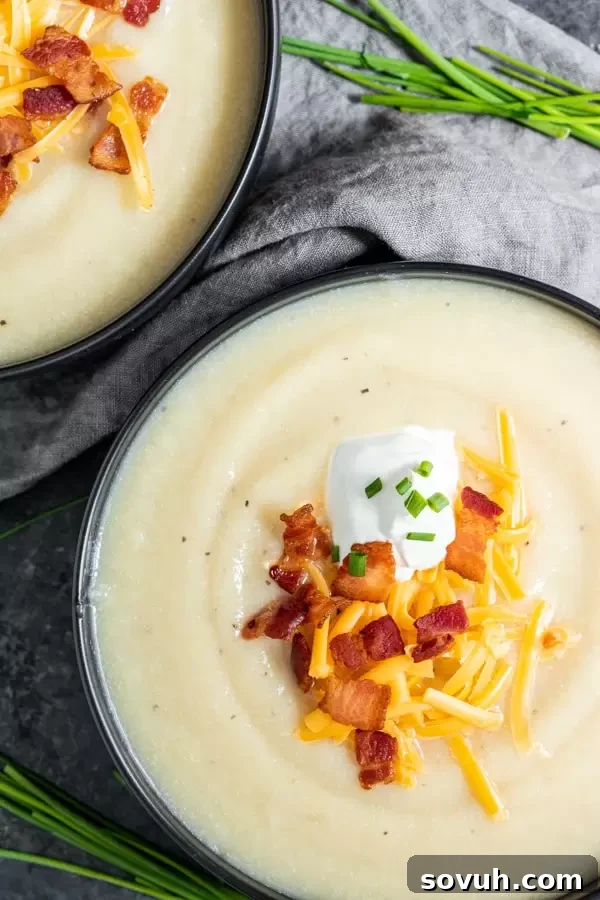 Instant Pot Loaded Cauliflower Soup is the perfect keto soup for Fall, garnished with crisp bacon and fresh parsley.