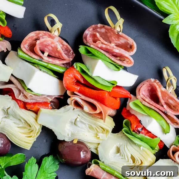 Italian Antipasto skewers on a black platter