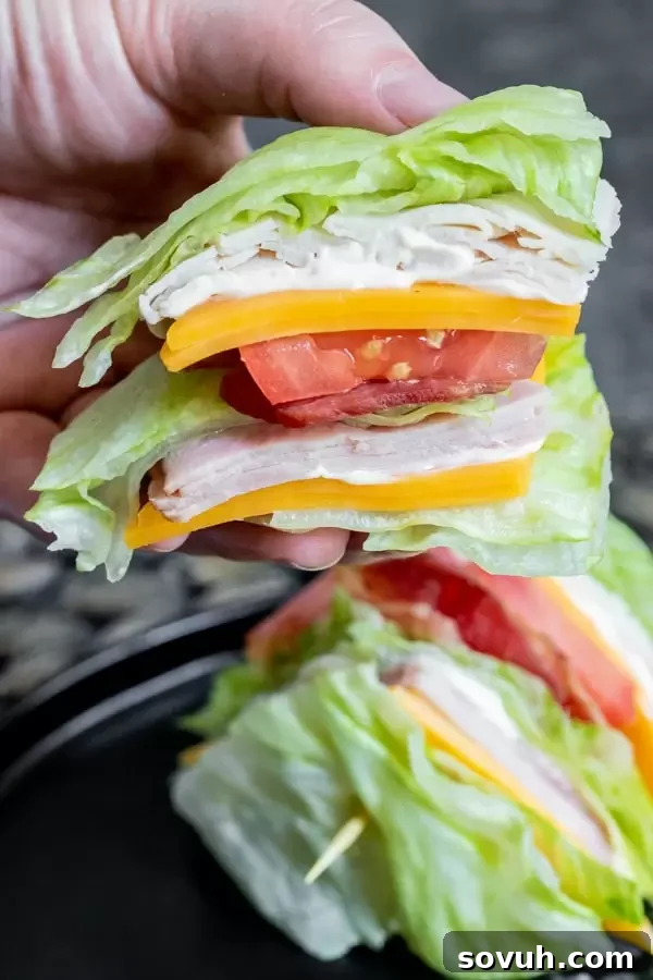 Two Keto Club Sandwiches cut into wedges, ready to be served, highlighting the fresh and colorful ingredients.