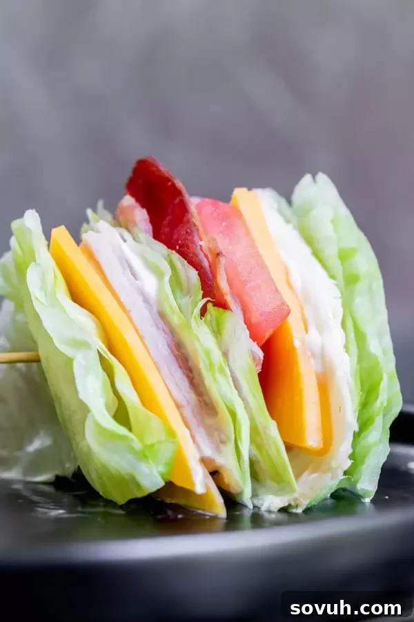 Stacked ingredients of a Keto Club Sandwich before being cut, showing the fresh and vibrant layers.