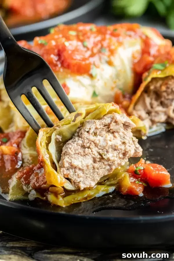 Keto Instant Pot Cabbage Rolls cut open on a fork, showing the delicious filling and tender cabbage.