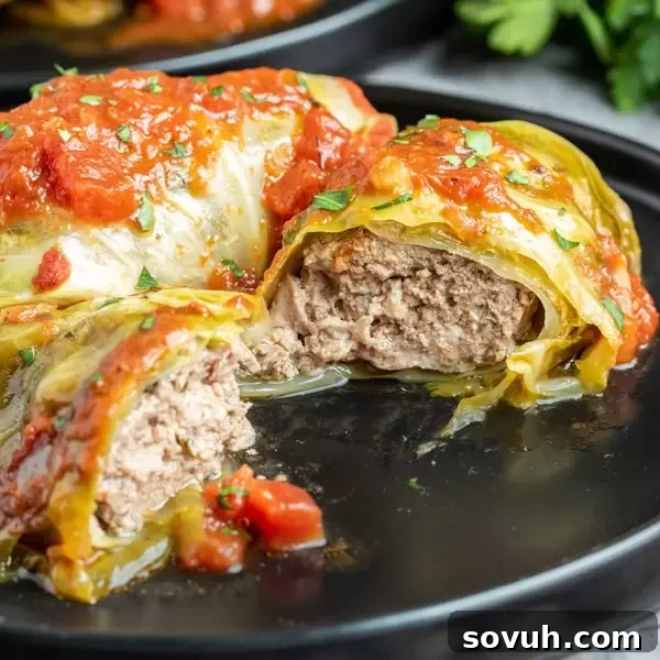 A plate of freshly cut Keto Instant Pot Cabbage Rolls, showcasing the tender cabbage and rich filling.
