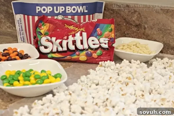 Colorful Skittles popcorn mix with white chocolate, a sweet and salty snack perfect for movie nights, Game Day, or kids' parties.