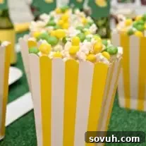 Vibrantly colored Skittles popcorn, a sweet and salty treat for Game Day parties.