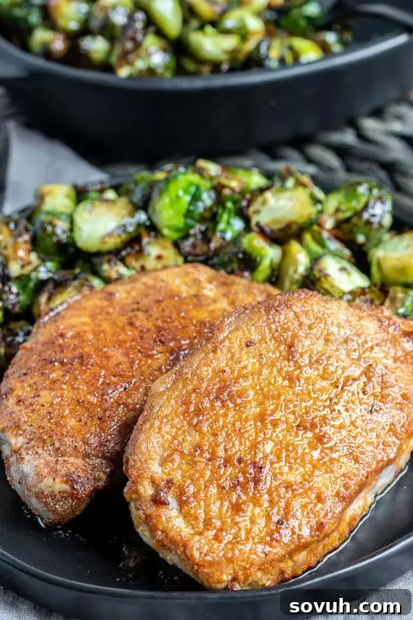Close-up of a low carb Air Fryer Pork Chop, showing its juicy interior and crispy seasoning.