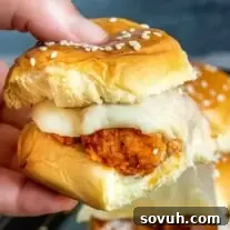 holding buffalo chicken sliders with cheese