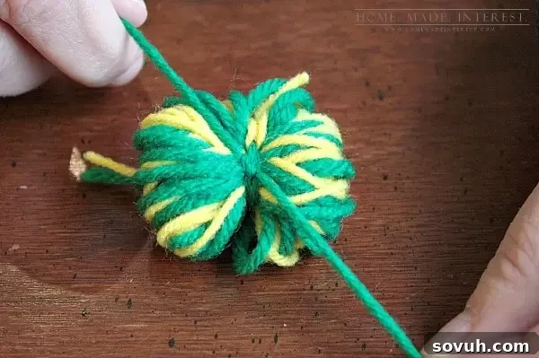 This simple craft tutorial on how to make yarn pom poms will change your life! You’ll want to put yarn pom poms everywhere! They are great for party decorations, garlands and banners, and cupcake toppers! 