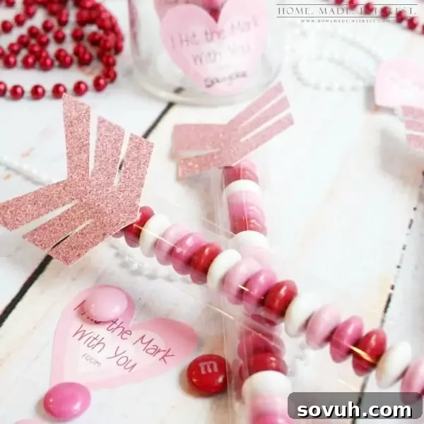 Close-up view of a cellophane bag filled with colorful Valentine's Day M&Ms, ready to become a Cupid's Arrow favor.