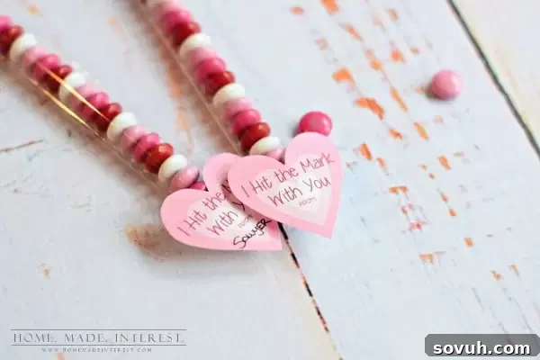 Detailed shot of the scrapbook paper arrow tail being crafted for a Valentine's Day Cupid's Arrow favor.
