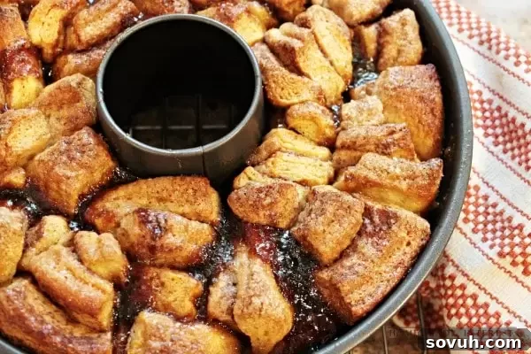 Warm Orange Caramel Pecan Monkey Bread just out of the oven, still in the bundt pan, with steam gently rising, showcasing its golden-brown crust.