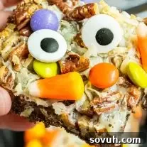 Halloween Magic Cookie Bars with candy corn and M&Ms on top