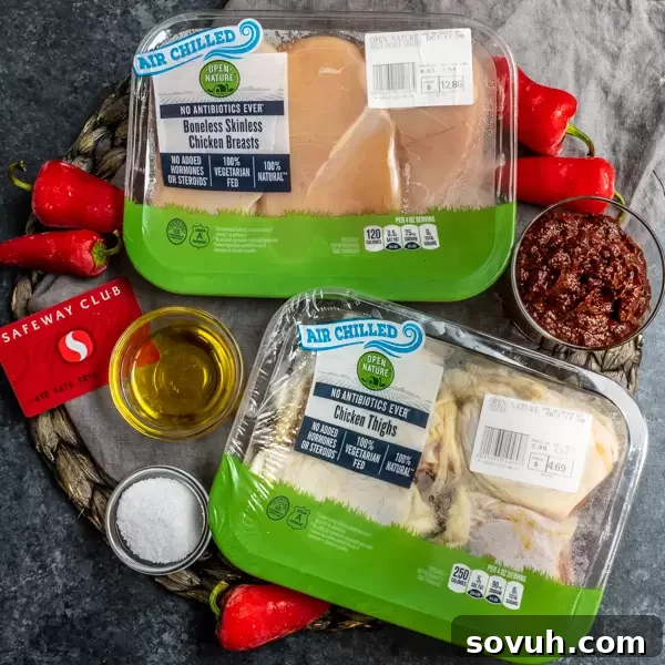 Aromatic Harissa Glazed Chicken 3 Top shot of raw chicken, harissa paste, and fresh peppers, highlighting the key ingredients.