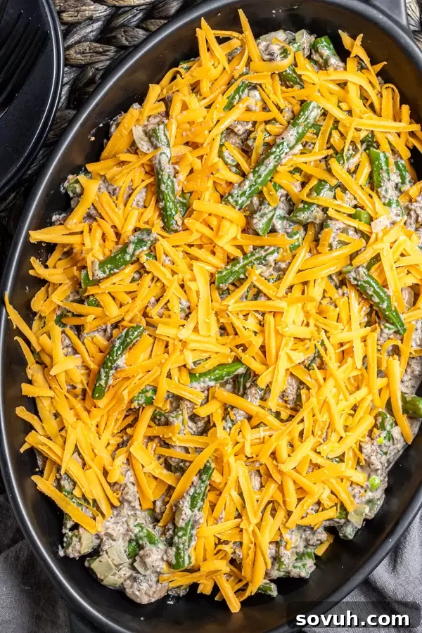 Keto Green Bean Casserole with cheddar cheese on top