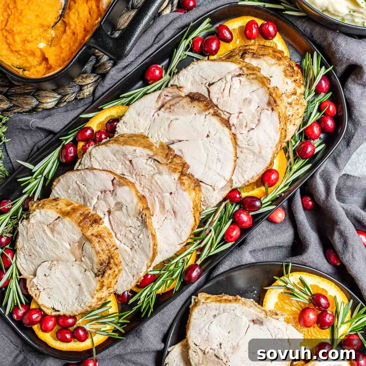 A beautifully roasted Instant Pot Turkey Breast, garnished with vibrant orange slices and fresh cranberries, presented on a festive platter, ready for a holiday meal.