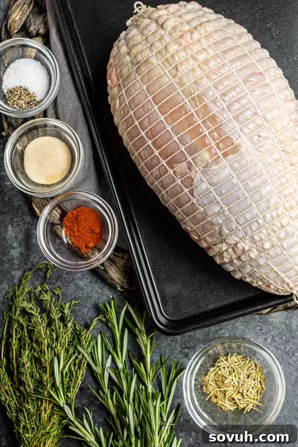 A collection of fresh ingredients laid out, including a raw turkey breast, various herbs and spices in small bowls, olive oil, butter, and chicken broth, prepared for making Instant Pot Turkey Breast.