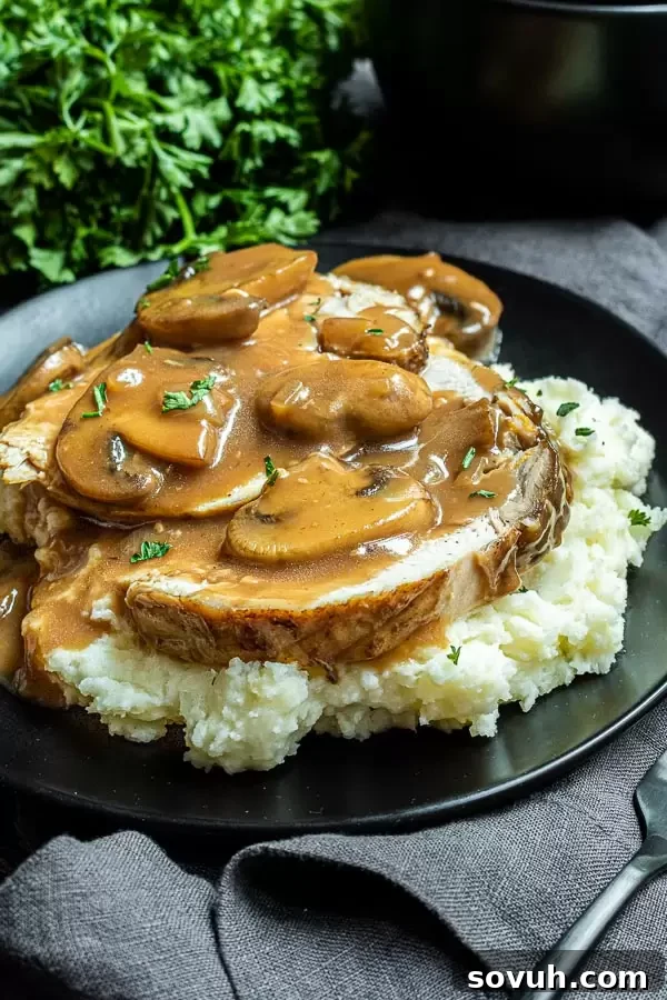 Succulent Turkey Marsala 5 Plated Turkey Marsala garnished with fresh green parsley, served on a white plate with a fork in the background, ready to be enjoyed.