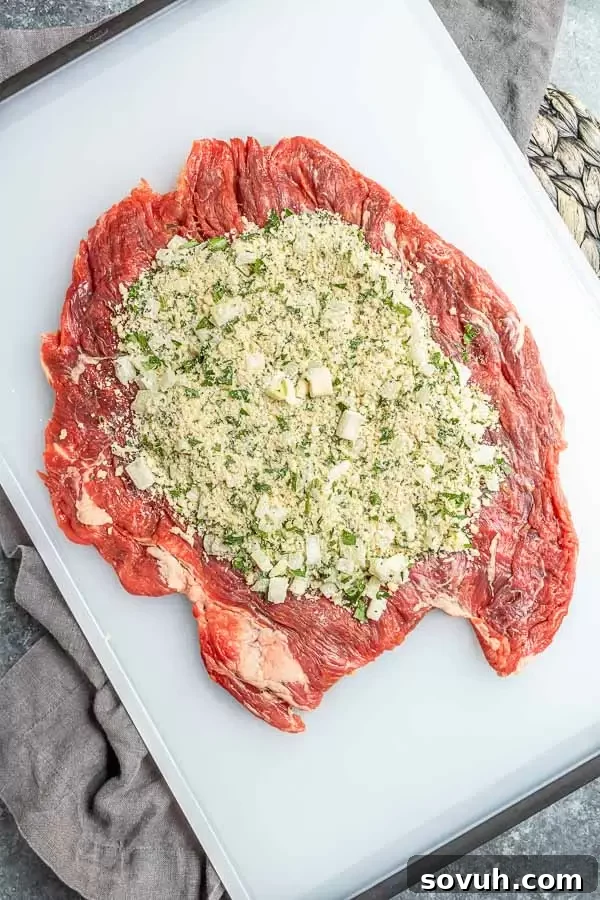 rolled out flank steak with filling to make Beef Braciole