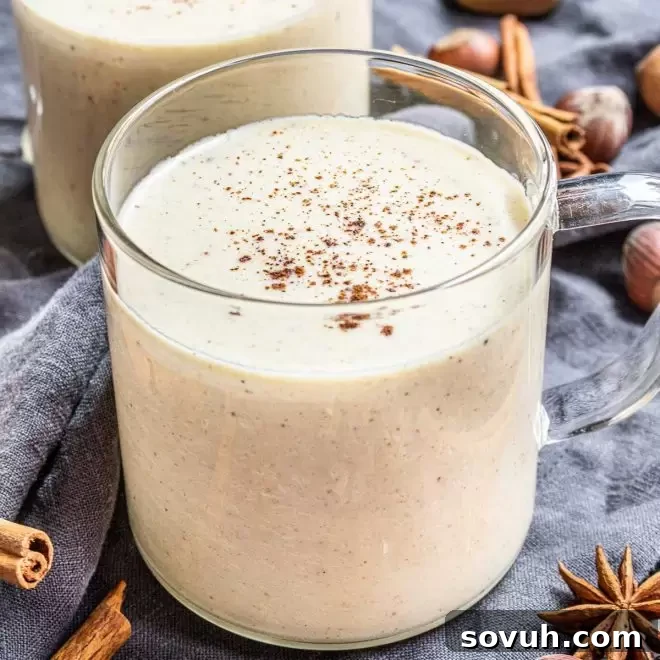 Keto Eggnog in a cup with cinnamon on top