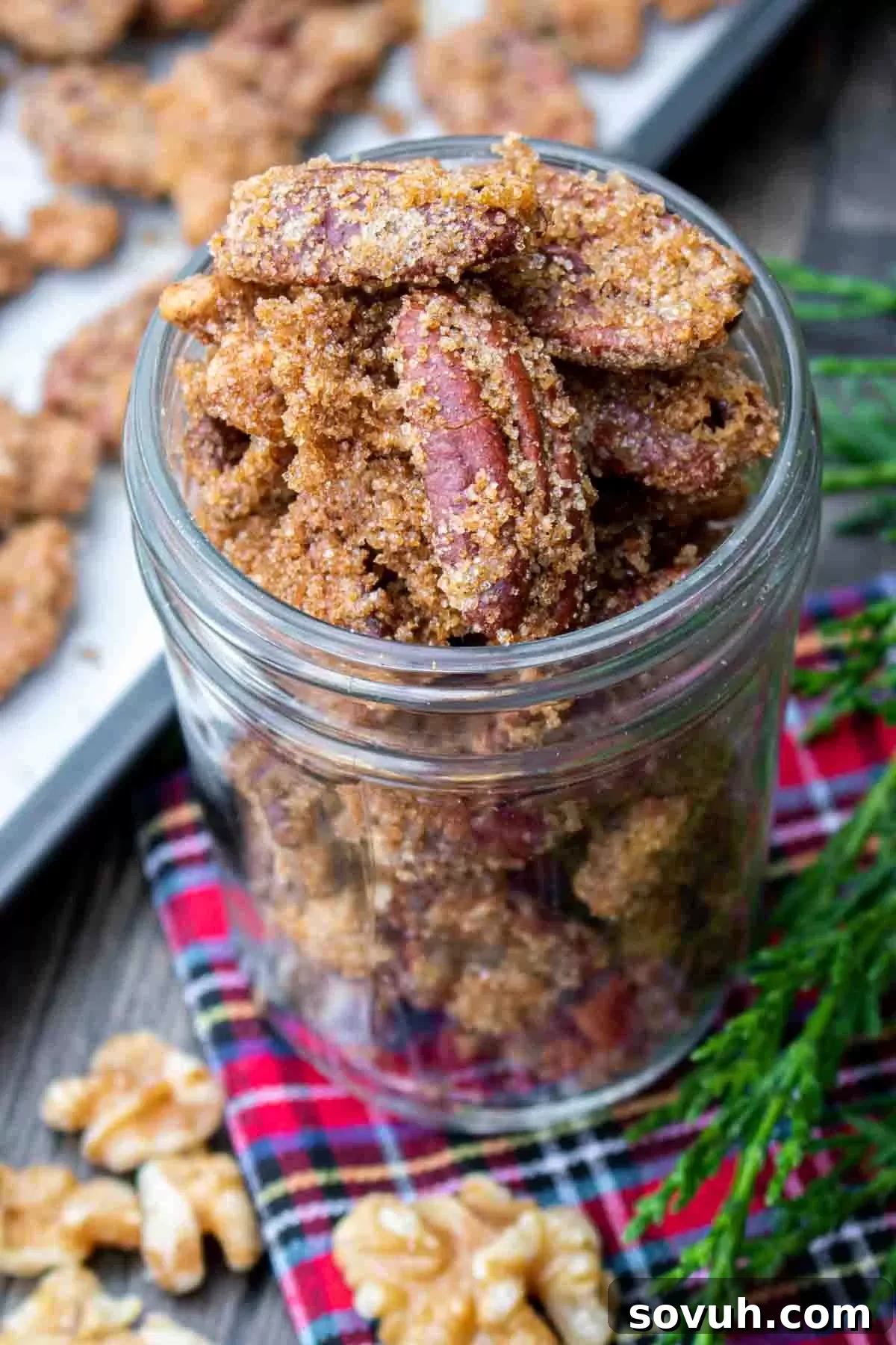 A mason jar overflowing with candied nuts, ready for gifting or serving.