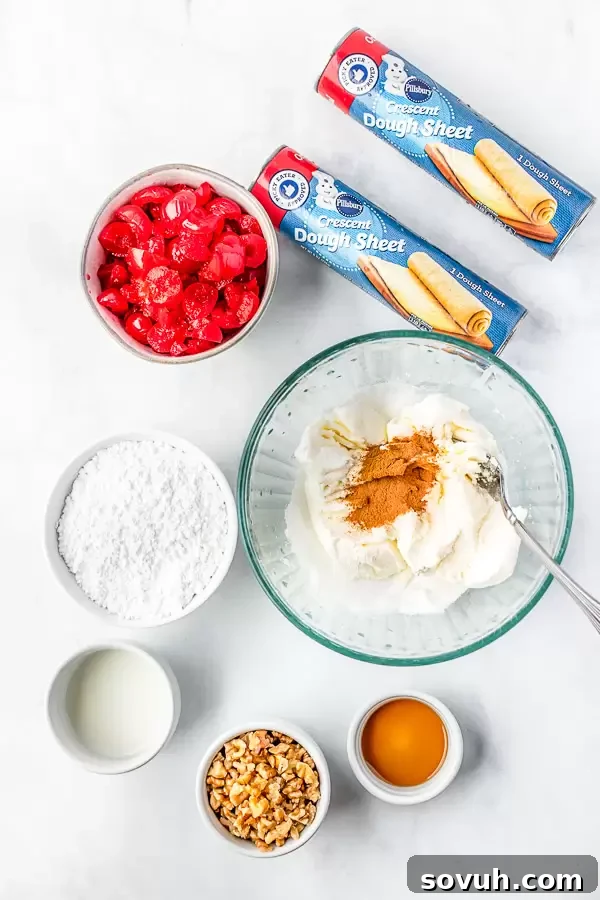 A selection of fresh ingredients including a block of cream cheese, a jar of maraschino cherries, a bag of walnuts, and baking staples laid out on a table, ready for preparing the Holiday Crescent Ring.
