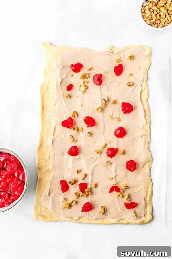 A sheet of unrolled crescent dough laid flat on parchment paper, ready to be filled.