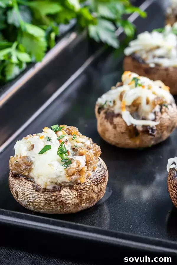 Low carb Stuffed Mushrooms with Sausage on a pan, highlighting their keto-friendly nature.
