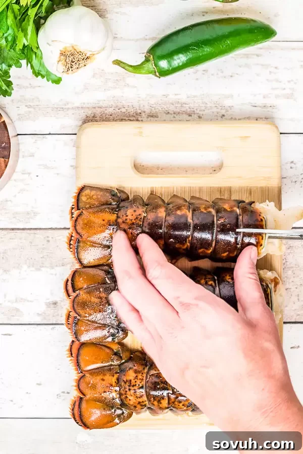 Detailed process of how to prepare a broiled lobster tail, showing the shell being cut with kitchen shears