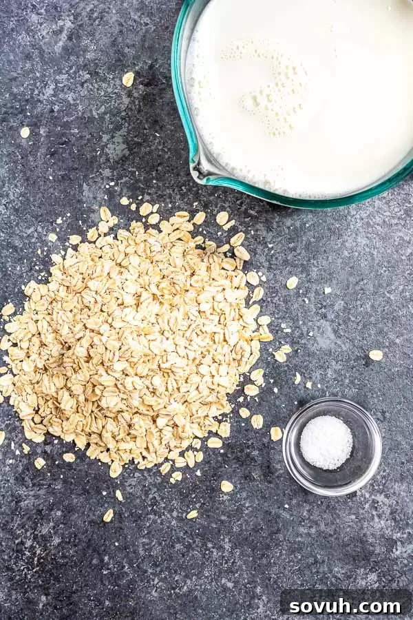 A selection of ingredients laid out on a wooden board, including oats, a carton of almond milk, a measuring cup, and a spoon, all ready for making Instant Pot Oatmeal.