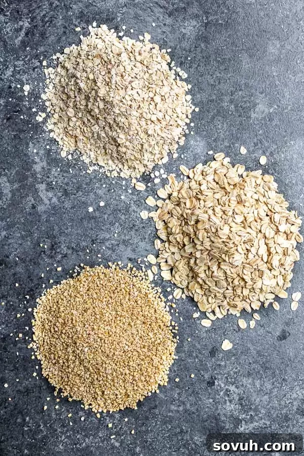 Three glass jars filled with different types of oats: steel-cut, rolled, and quick oats, illustrating the variety available for Instant Pot Oatmeal.