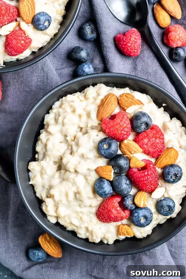 A beautifully presented bowl of Instant Pot Oatmeal, topped with fresh blueberries, raspberries, and sliced almonds, ready to be enjoyed.