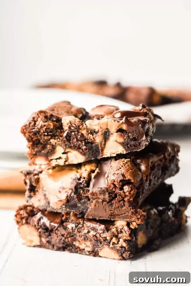 Stack of freshly baked Dark Chocolate Peanut Butter Brownies, showcasing their rich, fudgy texture and peanut butter swirls.