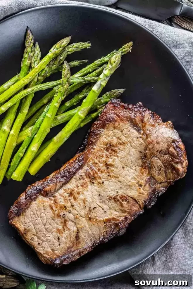 Air Fryer Steak on a plate with asparagus