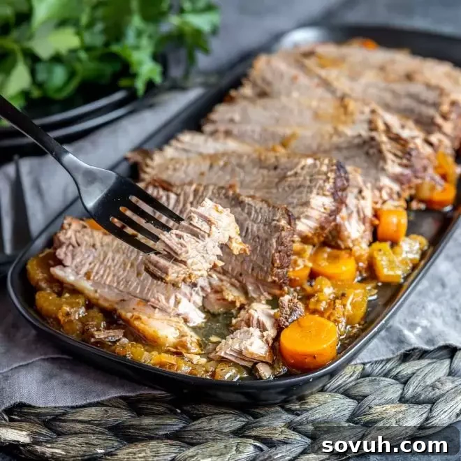 Instant Pot Brisket on a fork, showcasing its tenderness