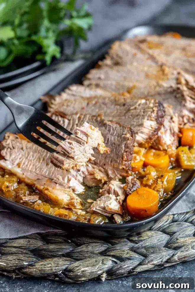 Instant Pot Brisket on a fork, showing its juicy texture