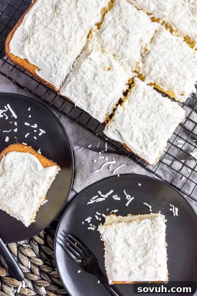A cooling rack holds a whole Coconut Sheet Cake and several slices on individual plates, tempting guests to try a piece.