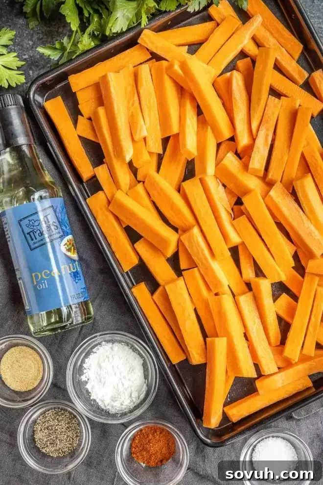 Ingredients for making crispy Air Fryer Sweet Potato Fries laid out on a wooden board.