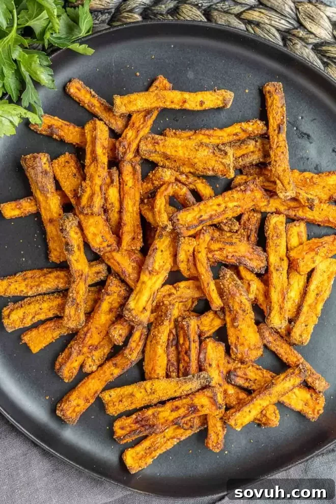 A close-up of healthy homemade Air Fryer Sweet Potato Fries, showing their crispy texture.